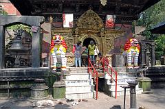 10 Kathmandu Valley Sankhu Vajrayogini Temple Entrance With Two White Snow Lions, Bells and Torana Door 